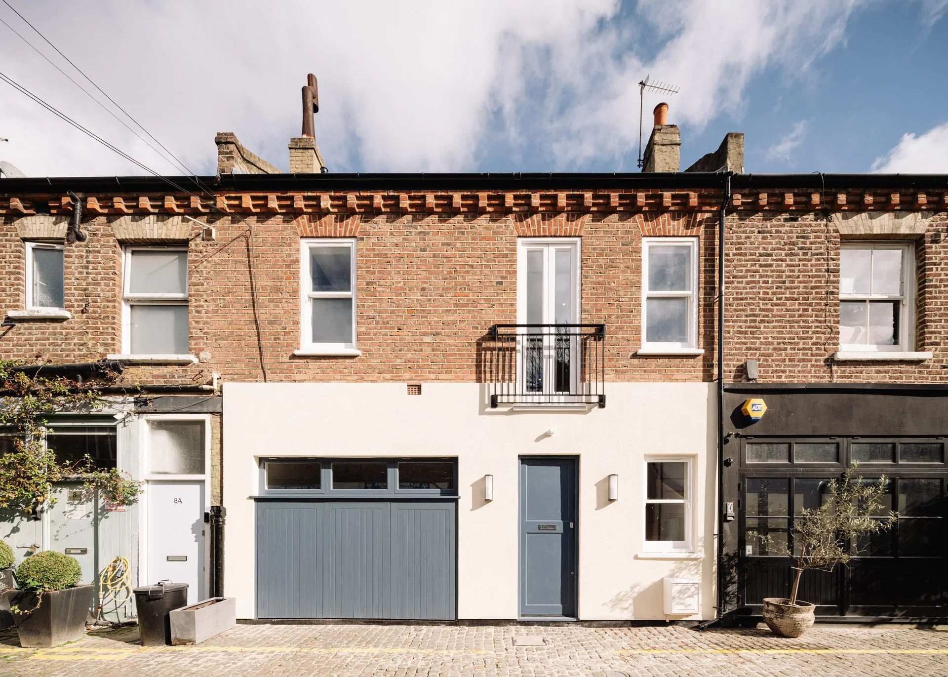 Russell Gardens Mews, a new-build mews house in Kensington by Studio AROS, seen from the cobbled mews