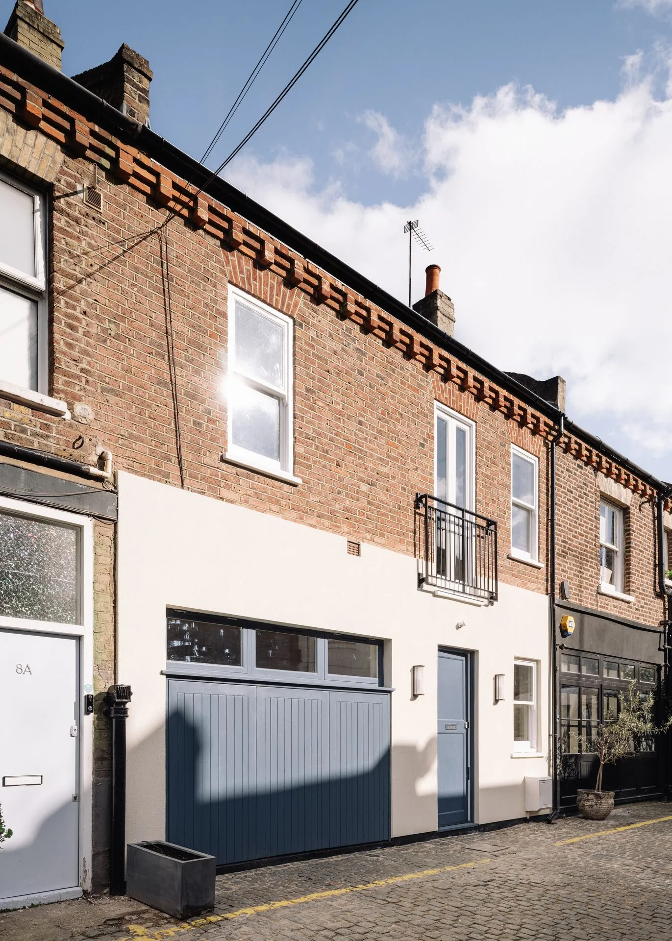 Contemporary interior at Russell Gardens Mews with warm timber and tactile plaster