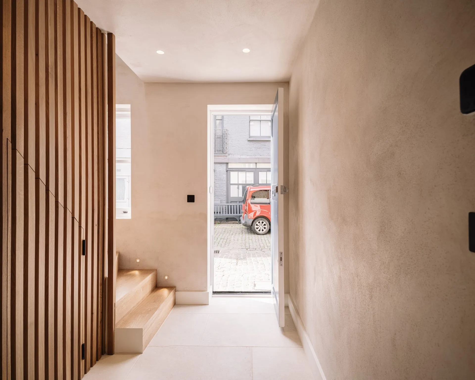 Triple-height stairwell bringing daylight into the centre of Russell Gardens Mews, Holland Park, Kensington