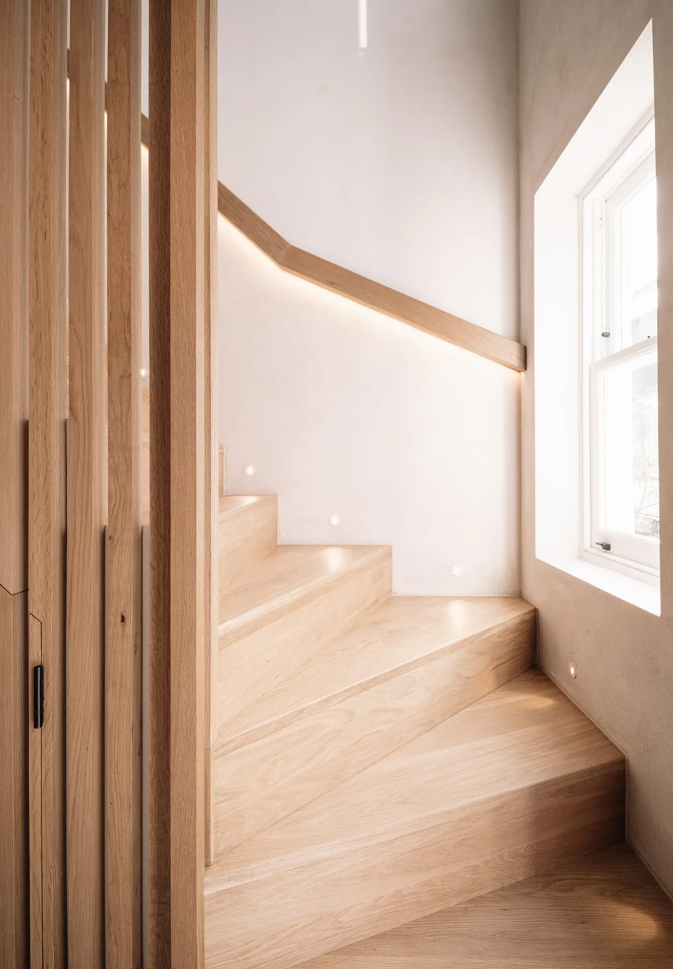 Stone and brass bathroom detailing at Russell Gardens Mews